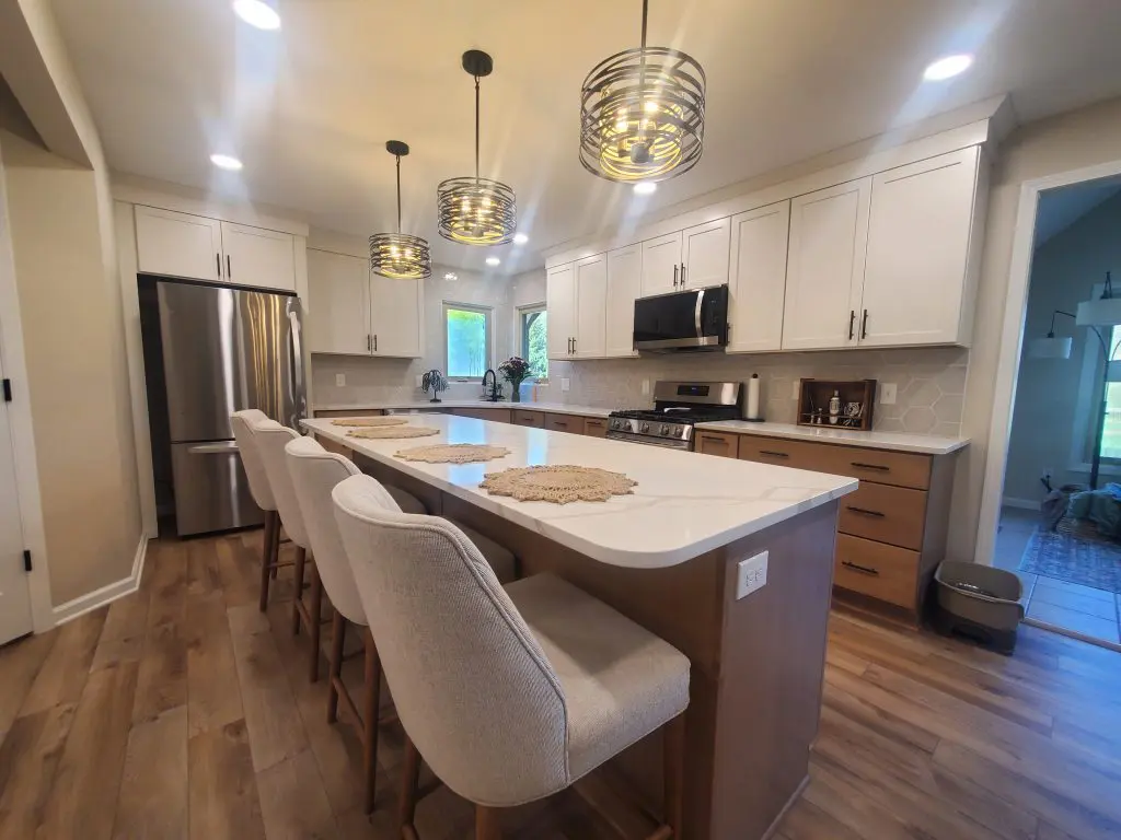 Recently remodeled kitchen with white countertops and white cabinets.
