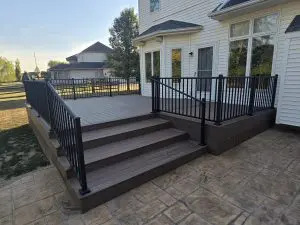 Custom built desk with dark wood and a black railing.